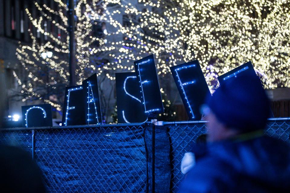 A group of people calling for ceasefire outside during the annual Menorah in the D at Campus Martius in Detroit on Thursday, Dec. 7, 2023.