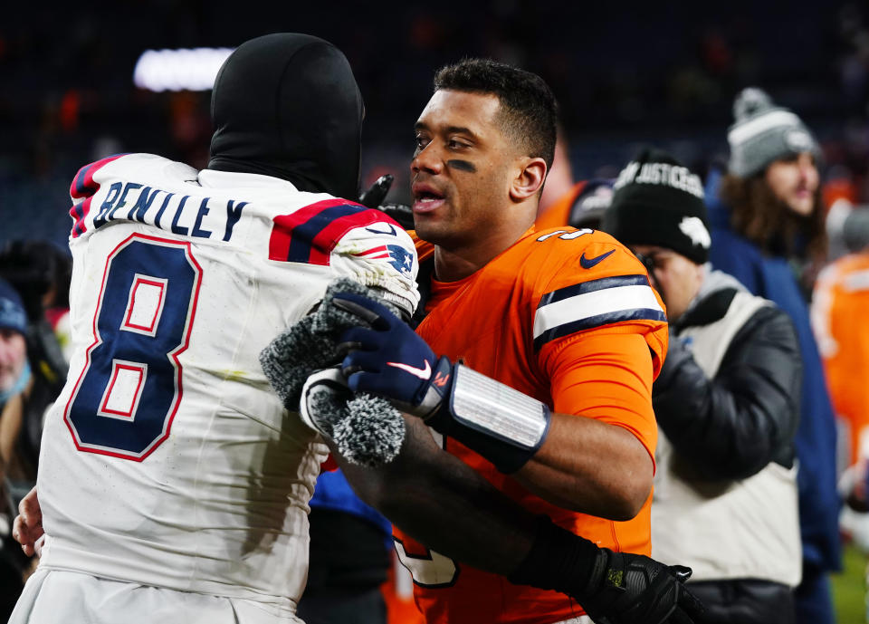 Denver Broncos quarterback Russell Wilson, right, greets New England Patriots linebacker Ja'Whaun Bentley after an NFL football game in Empower Field at Mile High, Sunday, Dec. 24, 2023, in Denver. (AP Photo/Geneva Heffernan)