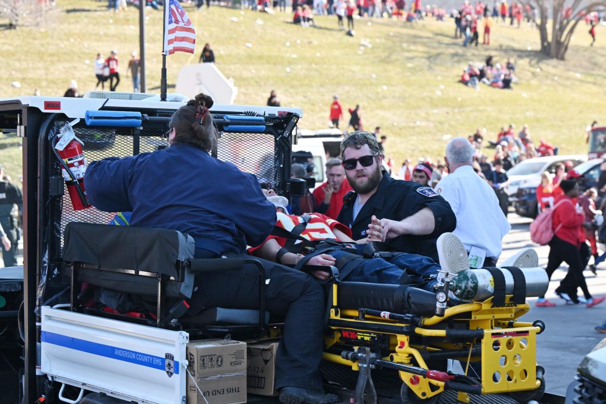 Fans receive medical assistance after shots were fired after the Chiefs Super Bowl parade.