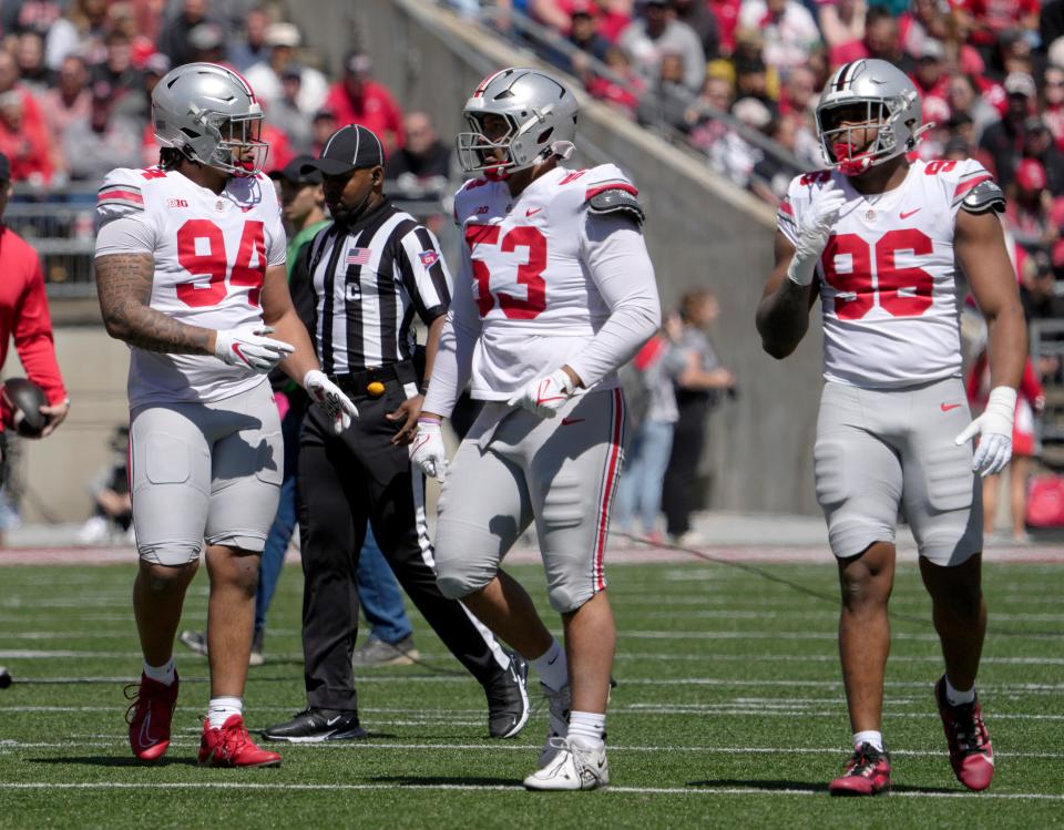 April 13, 2024; Columbus, Ohio, USA; 
Ohio State Buckeyes defensive linemen Jason Moore (94) and Will Smith Jr. (53), and long snapper Collin Johnson (96) compete during the first half of the LifeSports spring football game at Ohio Stadium on Saturday.