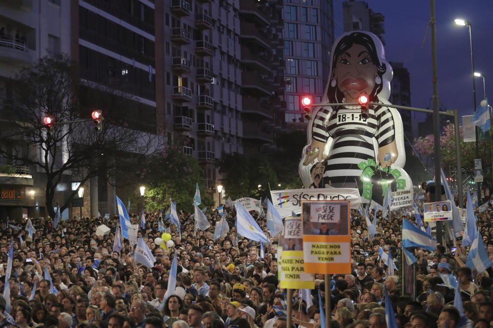 Supporters of Argentine President Mauricio Macri, who is running for reelection with the "Juntos Por el Cambio" party, display a large, cartoon-like image of former President Cristina Fernandez de Kirchner, who is running for vice president on another ticket, during Macri's campaign rally in Cordoba, Argentina, Thursday, Oct. 24, 2019. Argentina will hold its presidential election on Oct. 27. (AP Photo/Nicolas Aguilera)