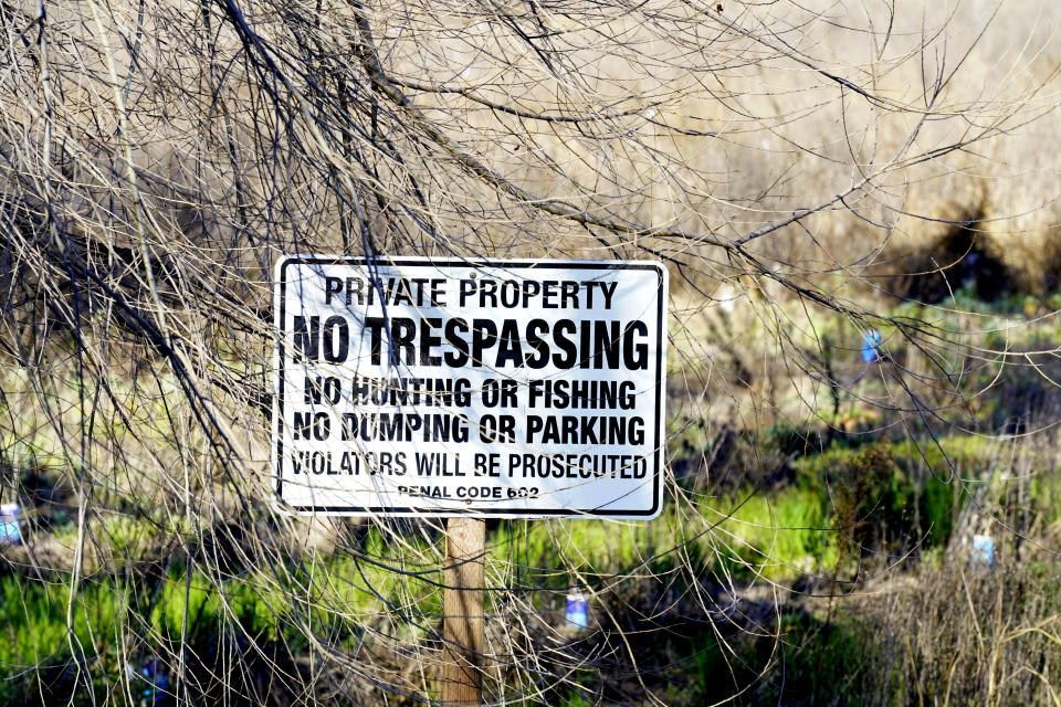 A "No Trespassing" sign stands on the Dos Rios Ranch Preserve, California's largest single floodplain restoration project in Modesto, Calif., on Wednesday, Feb. 16, 2022. The sign is protecting land where native trees and shrubs have been planted to draw wildlife back to the land along the Tuolumne and San Joaquin rivers. (AP Photo/Rich Pedroncelli)