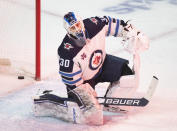 Winnipeg Jets goaltender Laurent Brossoit reacts after giving up a goal to Montreal Canadiens' Jeff Petry during the third period of an NHL hockey game Saturday, March 6, 2021, in Montreal. (Graham Hughes/The Canadian Press vIa AP)