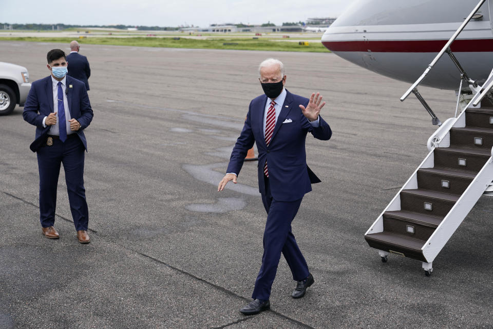 FILE - In this Tuesday, Sept. 15, 2020 file photo, Democratic presidential candidate and former Vice President Joe Biden steps off a plane at Tampa International Airport in Tampa, Fla., on a visit for campaign events. On Friday, Sept. 18, 2020, The Associated Press reported on stories circulating online incorrectly asserting a video of Biden deplaning here shows him waving to an empty field. An Associated Press reporter traveling with Biden on Tuesday confirmed he was waving to firefighters and other ground personnel outside the frame of the video. (AP Photo/Patrick Semansky)