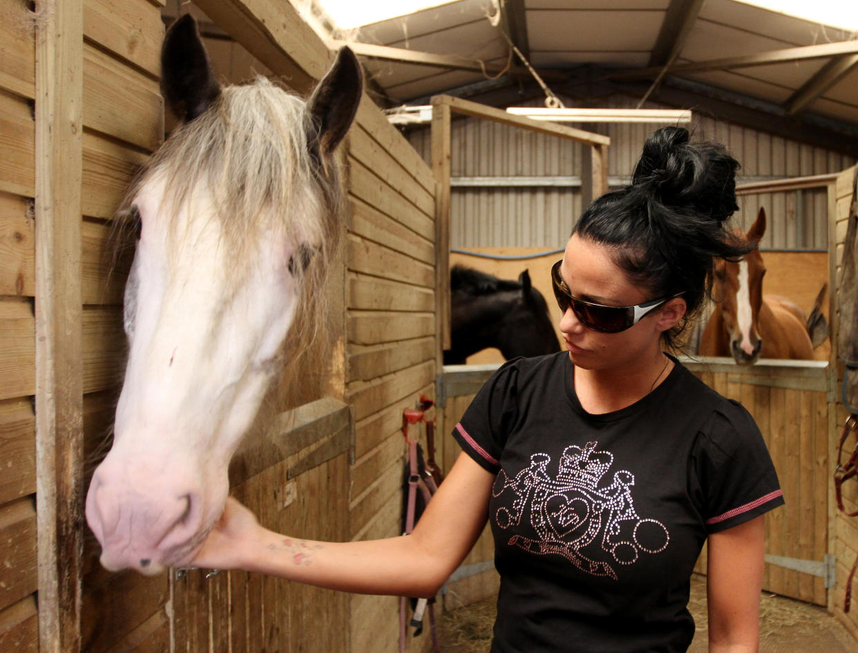 Katie Price meets the horses during a visit to the Horse Refuge in Wittersham, Kent, which is threatened with closure.