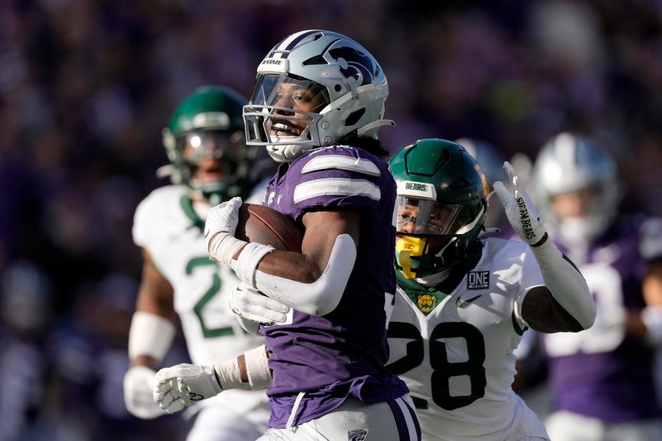 Kansas State running back DJ Giddens (31) is chased by Baylor's Devyn Bobby (28) as he runs for a first down on Saturday at Bill Snyder Family Stadium. Giddens rushed for 115 yards.