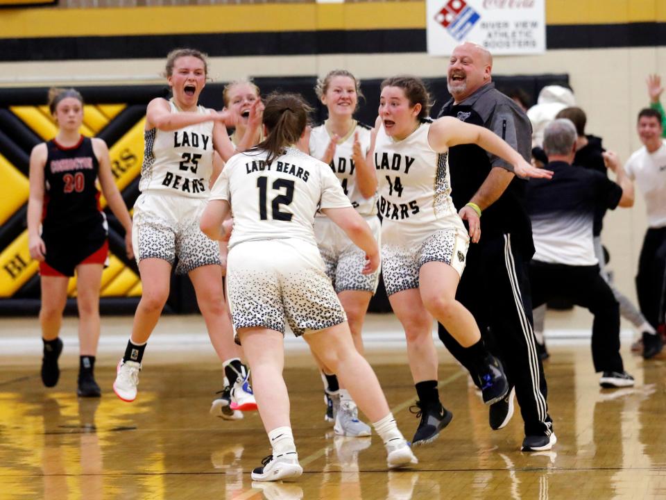 Teammates mob Prestyn Patterson (12) after she hit a 3-pointer at the buzzer to secure River View's 40-39 win against visiting Coshocton on Monday night at Luther Stover Gymnasium in Warsaw.