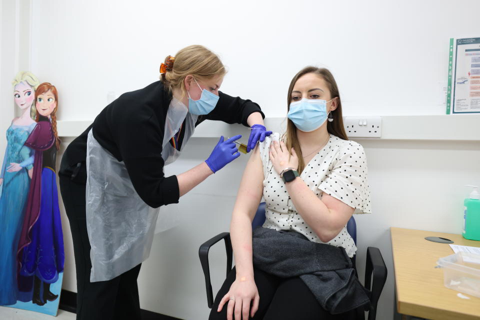 Holly Fox (right) receives a Moderna Omicron COVID-19 booster vaccine in a clinical study at St George's, University of London, in Tooting, south west London. Picture date: Thursday February 17, 2022. (Photo by James Manning/PA Images via Getty Images)