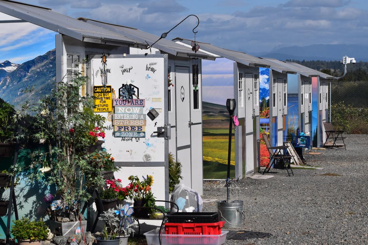 Plants and landscape decals decorate the outsides of Palisades Village's 40 pallet homes in Everett. Leaders from Kitsap County visited the site in 2023, and now a plan has been floated by a group of service providers to possibly create a similar site in Bremerton.