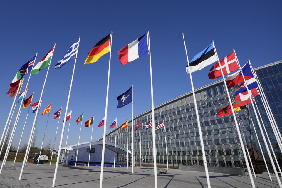 An empty flagpole stands between the national flags of France and Estonia outside NATO headquarters in Brussels, Monday, April 3, 2023. Finland awaits an official green light to become the 31st member of the world's biggest security alliance as NATO foreign ministers prepare to meet in Brussels on Tuesday and Wednesday. (AP Photo/Virginia Mayo)