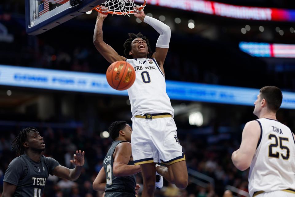 Mar 12, 2024; Washington, D.C., USA; Notre Dame Fighting Irish forward Carey Booth (0) dunks the ball as Georgia Tech Yellow Jackets forward Baye Ndongo (11) looks on in the second half at Capital One Arena. Mandatory Credit: Geoff Burke-USA TODAY Sports