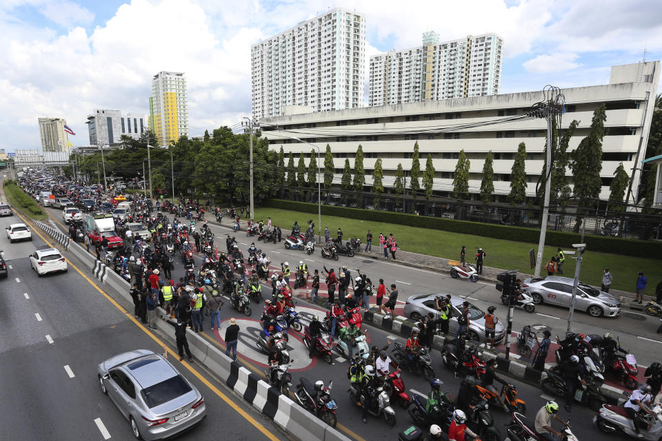 Anti-government protesters block the road with cars and motorcycles as part of their "car mob" demonstrations along several roads in Bangkok, Thailand, Sunday, Aug. 29, 2021. A long line of cars, trucks and motorbikes wended its way Sunday through the Thai capital Bangkok in a mobile protest against the government of Prime Minister Prayuth Chan-ocha. The protesters on wheels hope their nonviolent action, dubbed a "car mob," can help force the ouster of Prayuth, whom they accuse of botching the campaign against the coronavirus. (AP Photo/Anuthep Cheysakron)