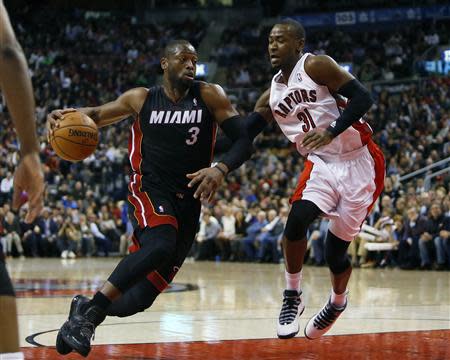 Nov 29, 2013; Toronto, Ontario, CAN; Miami Heat guard Dwyane Wade (3) moves the ball against Toronto Raptors guard Terrence Ross (31) at the Air Canada Centre. Miami defeated Toronto 90-83. Mandatory Credit: John E. Sokolowski-USA TODAY Sports