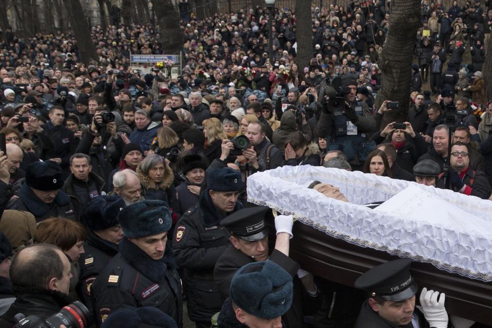 FILE - People follow the coffin of slain opposition figure Boris Nemtsov at the Sakharov center in Moscow, Russia, Tuesday, March 3, 2015. . His death brought thousands into the streets of Moscow, where they were allowed to protest unimpeded by police – unlike the scene after the Feb. 16, 2024, death in prison of Alexei Navalny, a political foe of President Vladimir Putin. Mourners trying to lay flowers at makeshift memorials to Navalny were quickly arrested. (AP Photo/Pavel Golovkin, File)