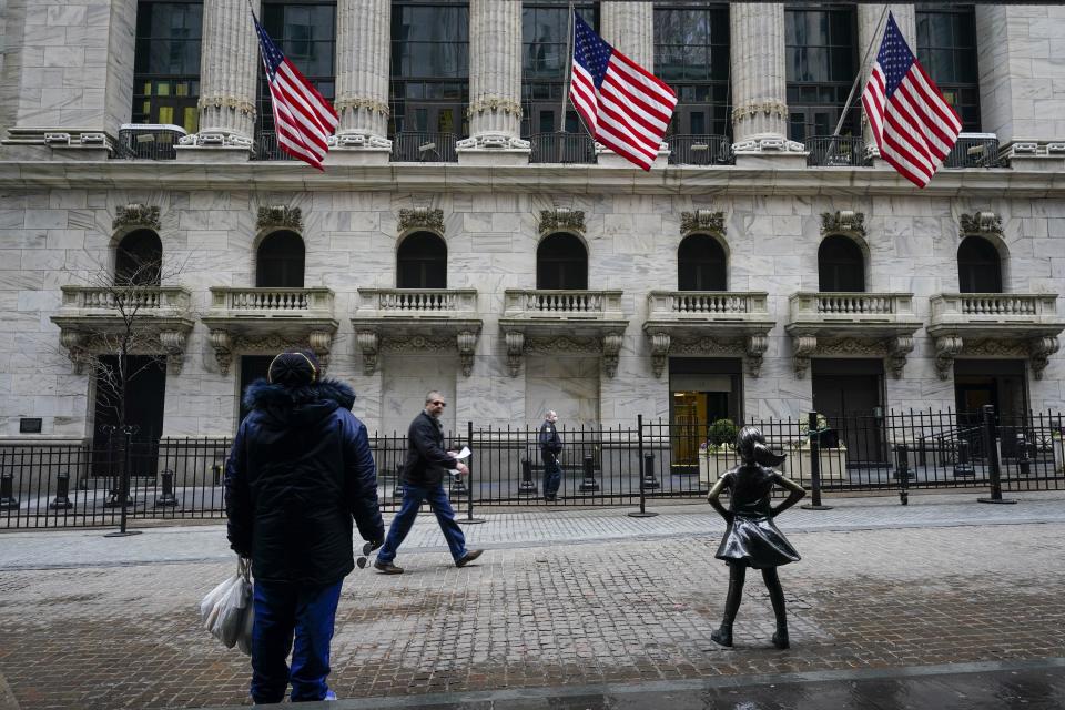 FILE - In this Feb. 16, 2021 file photo, pedestrians pass the New York Stock Exchange in New York. Stocks were slightly higher in early trading Friday, April 9, as a rise in bond yields helped lift the shares of energy and bank companies in the early going. (AP Photo/Frank Franklin II, File)