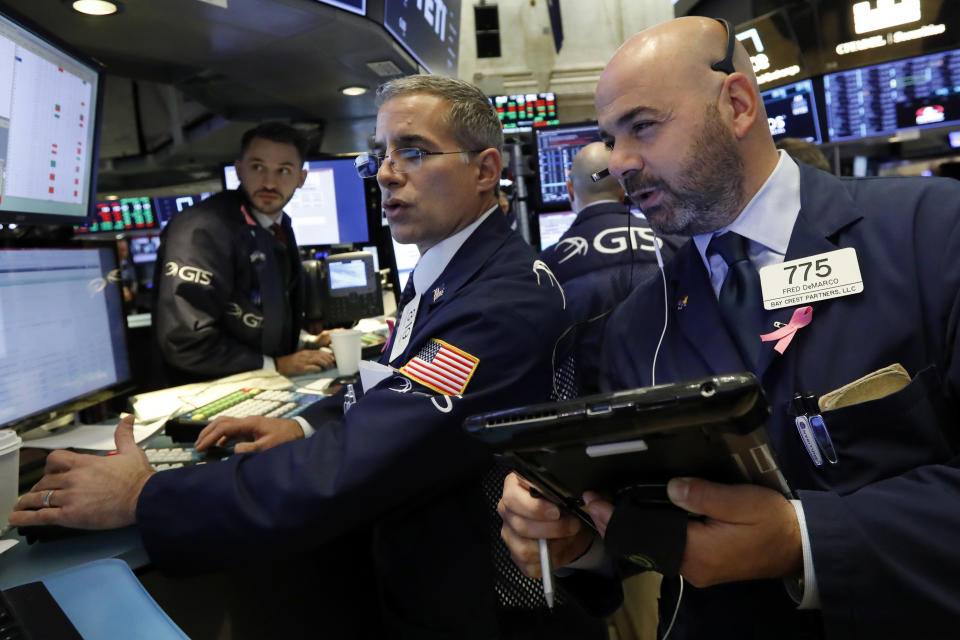 Specialist Anthony Rinaldi, left, works with trader Fred DeMarco on the floor of the New York Stock Exchange, Friday, Oct. 26, 2018. Stocks are opening broadly lower on Wall Street, a day after a massive surge, as a number of big companies reported disappointing results. (AP Photo/Richard Drew)