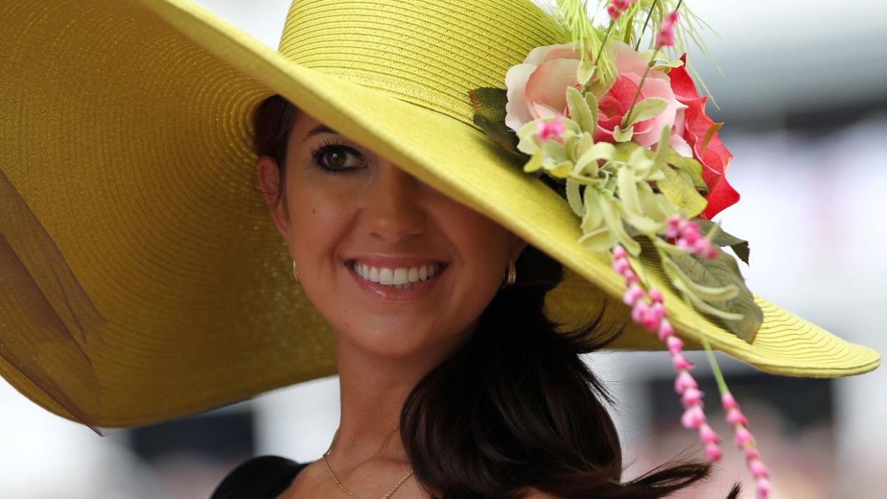 A fan looks on wearing her derby hat during the 137th Kentucky Derby at Churchill Downs in Louisville, Kentucky.