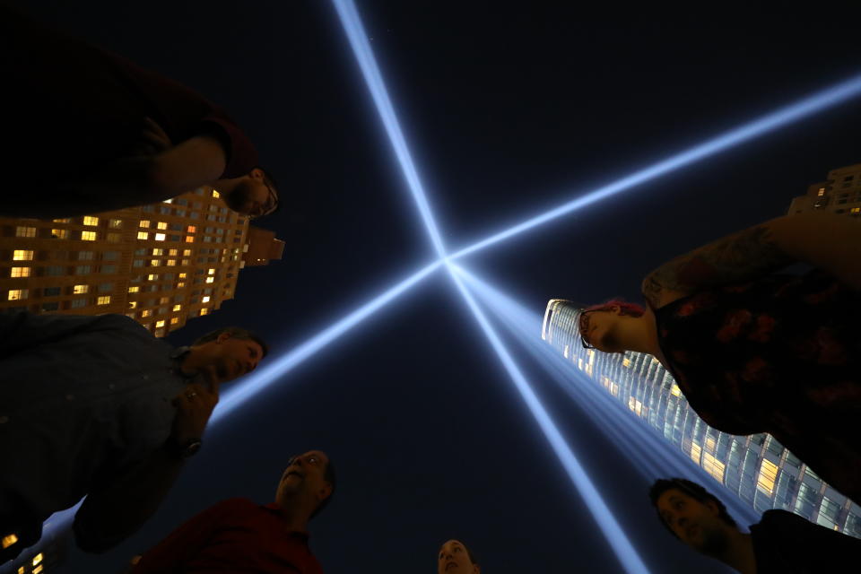 <p>Visitors stand inside the square comprising 44 lights that make up one tower of the Tribute in Light on Sept. 5, 2018. (Photo: Gordon Donovan/Yahoo News) </p>