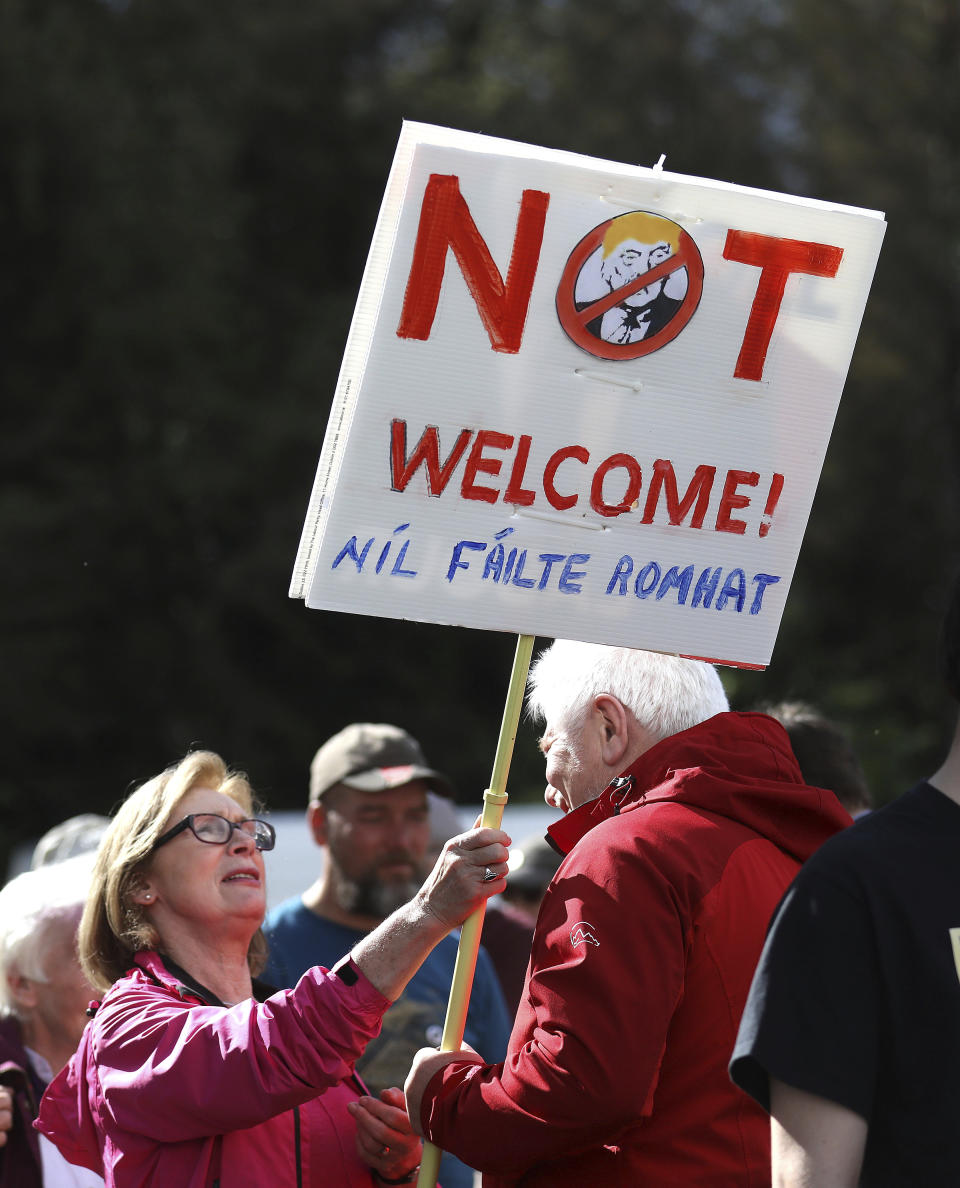 A demonstrator protests before the arrival of U.S President Trump at Shannon Airport in the west of Ireland, Wednesday, June 5, 2019. President Trump is staying overnight in Ireland before attending 75th anniversary of the D-Day landings events in northern France Thursday. (AP Photo/Peter Morrison)