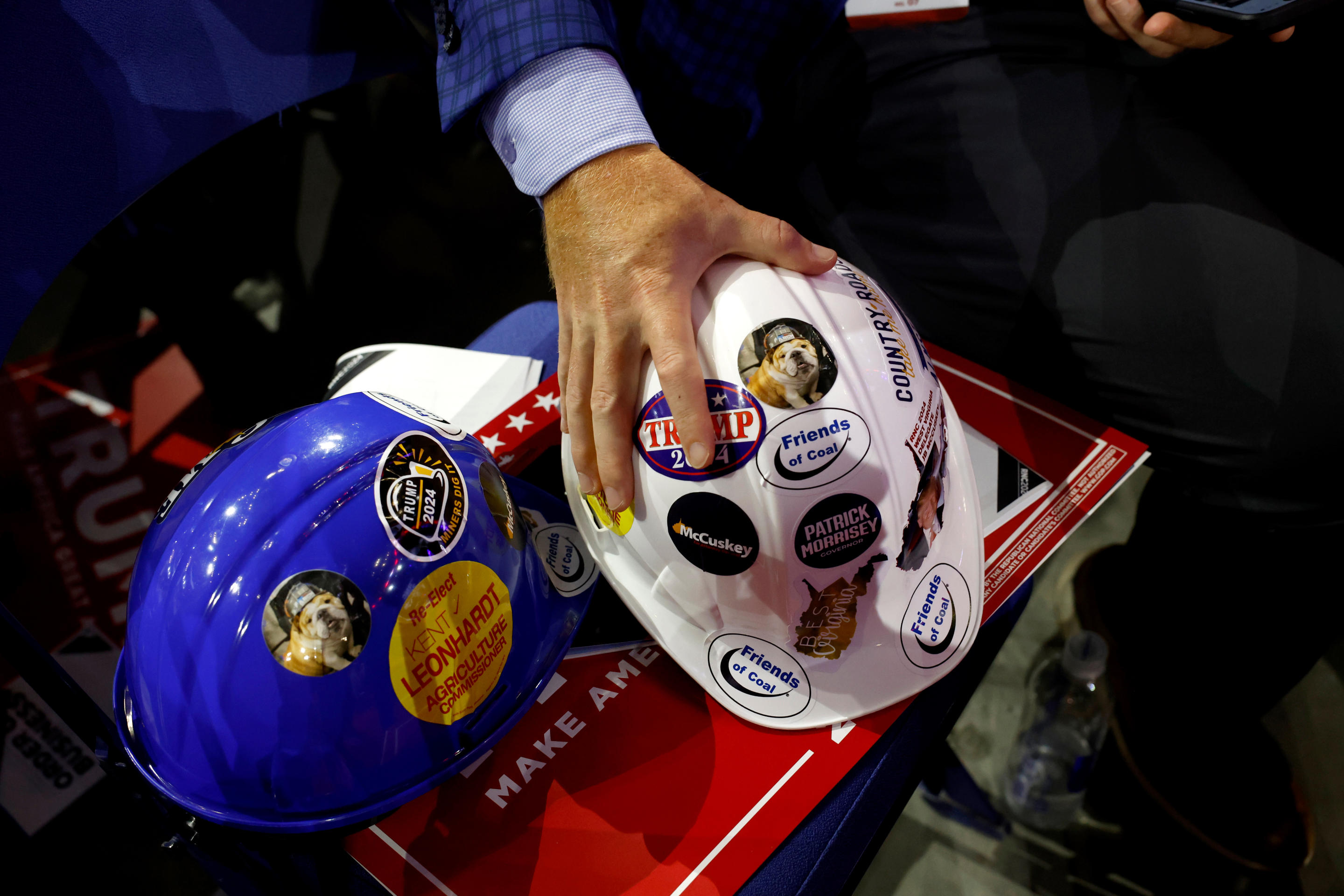 A delegate holds hardhats covered in Trump stickers at the convention on Monday. (Eva Marie Uzcategui/Bloomberg via Getty Images)