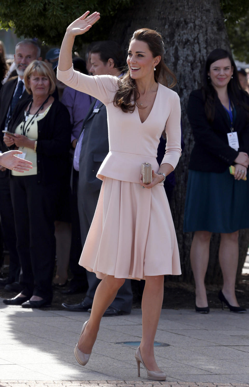 Britain's Kate, the Duchess of Cambridge, waves to the crowd as she arrives outside the Playford Civic Centre in Adelaide, Australia, suburb of Elizabeth, Wednesday, April 23, 2014. Prince William and Kate are undertaking a 19-day official visit to New Zealand and Australia with their son, George. (AP Photo/David Gray, Pool)