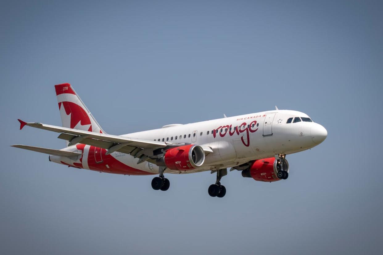 An Air Canada Rouge plane similar to this one hit another Air Canada plane at Vancouver International Airport Sunday afternoon.  (Ryan Mahle/CBC - image credit)