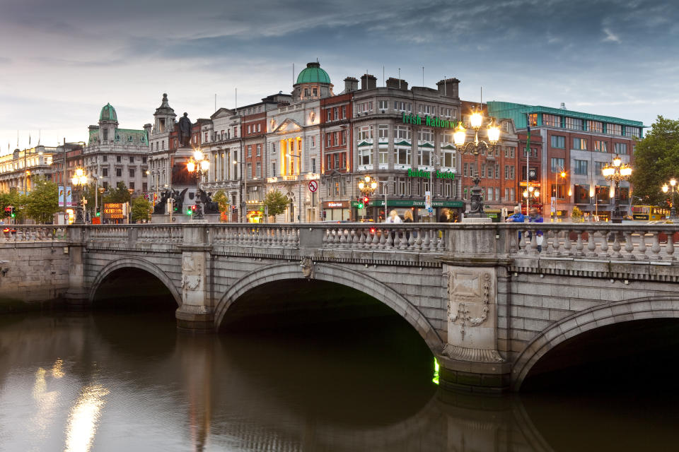 O'Connell Bridge over the River Liffey with Dublin city buildings and lights at dusk