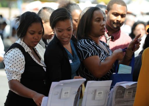 Job seekers collect employment information at an outdoor job fair at the Crenshaw Christian Center in South Los Angeles, August 2011. US President Barack Obama has bowed to Republicans in a row over the timing of his big jobs speech, which boded ill for hopes of a bipartisan compromise to revive the economy