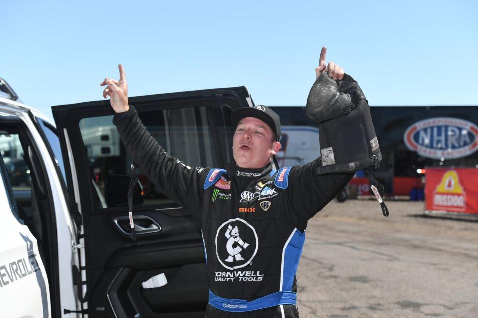 a man in a race car waving