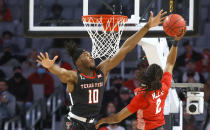 Texas Tech forward Tyreek Smith (10) blocks the shot of Houston guard Caleb Mills (2) during the first half of an NCAA college basketball game, Sunday, Nov. 29, 2020, in Fort Worth, Texas. (AP Photo/Ron Jenkins)