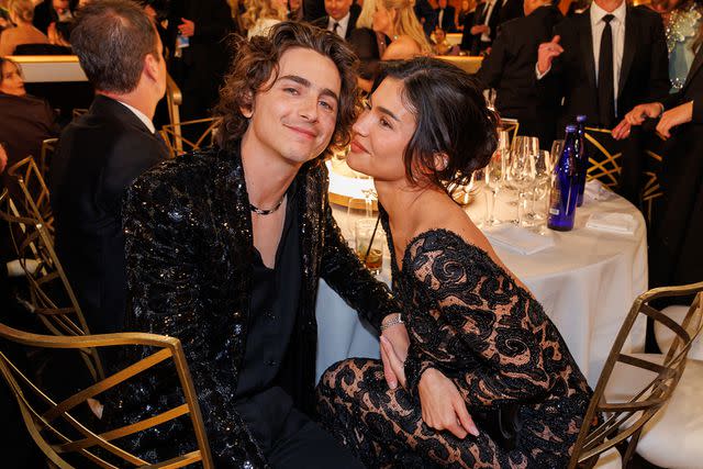 <p>Christopher Polk/Golden Globes 2024/Golden Globes 2024 via Getty</p> Timothée Chalamet and Kylie Jenner cozy up to each other at the 2024 Golden Globes