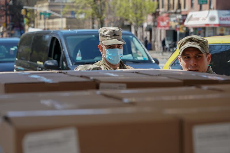 Members of the U.S. Army National Guard distribute boxes of free food provided by multiple New York City agencies in the Harlem neighborhood of Manhattan in New York