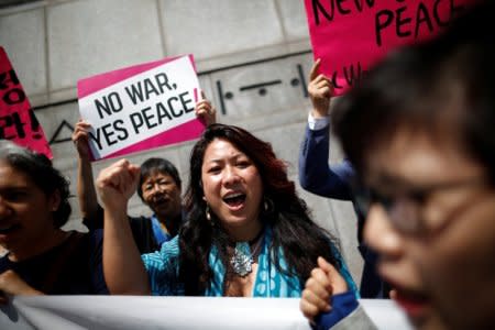 Women attend a protest against U.S. President Donald Trump near U.S. embassy in Seoul, South Korea, May 25, 2018. REUTERS/Kim Hong-Ji