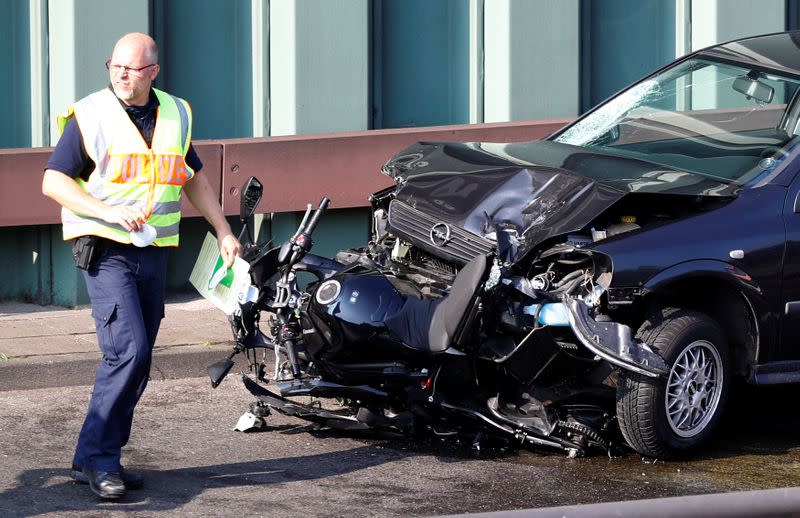 Police officers investigate the scene of a series of allegedly deliberate car crashes in Berlin