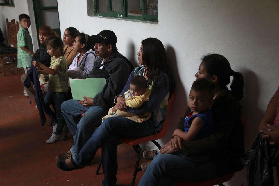 In this Tuesday, July 10, 2012 photo, parents wait to try to get their children's U.S. birth certificate stamped by Mexican authorities in Malinalco, Mexico. Because of the Byzantine rules of Mexican and U.S. bureaucracies, tens of thousands of U.S. born children of Mexican migrant parents now find themselves without access to basic services in Mexico - unable to officially register in school or sign up for health care at public hospitals and clinics that give free check-ups and medicines. (AP Photo/Dario Lopez-Mills)