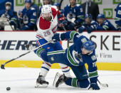 Montreal Canadiens defenseman Jeff Petry (26) fights for control of the puck with Vancouver Canucks left wing Tanner Pearson (70) during the second period NHL action in Vancouver, Monday, March 8, 2021. (Jonathan Hayward/The Canadian Press via AP)