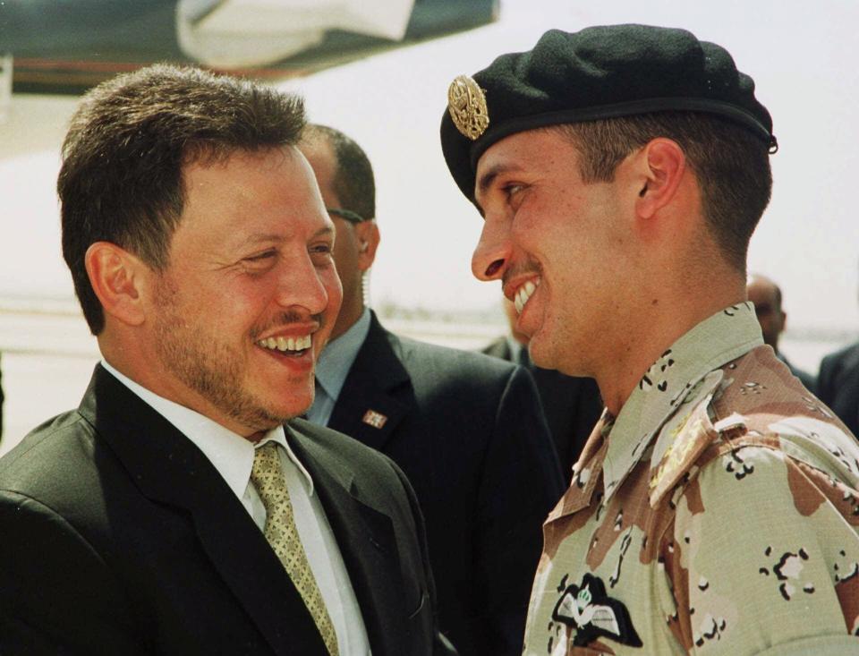 FILE - In this April 2, 2001, file photo, Jordan’s King Abdullah II laughs with his half brother Prince Hamzah, right, shortly before the monarch embarked on a tour of the United States. Abdullah and Hamzah are both sons of the beloved King Hussein, who ruled Jordan for nearly a half-century before his death in 1999. Abdullah had appointed Hamzah as crown prince upon his succession but stripped him of the title in 2004. (AP Photo/Yousef Allan, File)