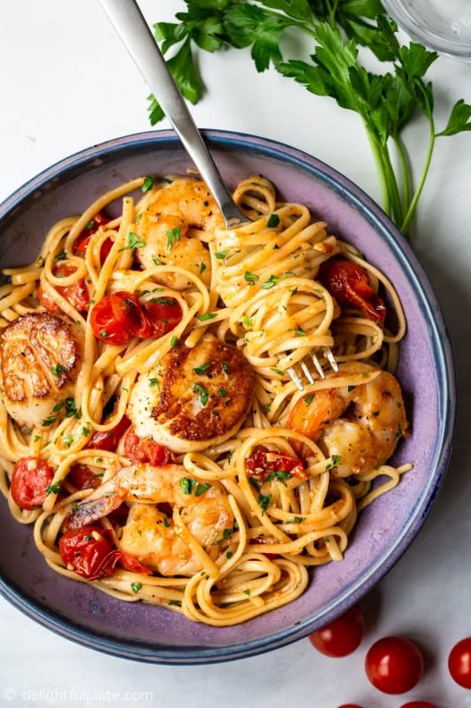 <p>Delightful Plate</p><p>This scallop shrimp pasta with burst cherry tomatoes is perfect for not only quick and simple weeknight meals but also fancy date-night dinners. It is so flavorful with sweetness from fresh seafood and umami from burst tomatoes.</p><p><strong>Get the recipe: <a href="https://delightfulplate.com/scallop-shrimp-pasta-cherry-tomatoes/" rel="nofollow noopener" target="_blank" data-ylk="slk:Scallop Shrimp Pasta with Burst Cherry Tomatoes;elm:context_link;itc:0;sec:content-canvas" class="link rapid-noclick-resp">Scallop Shrimp Pasta with Burst Cherry Tomatoes</a></strong></p>