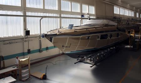 An employee works on a yacht at the Ferretti's shipyard in Sarnico, northern Italy, April 7, 2015. Picture taken on April 7, 2015.REUTERS/Stefano Rellandini