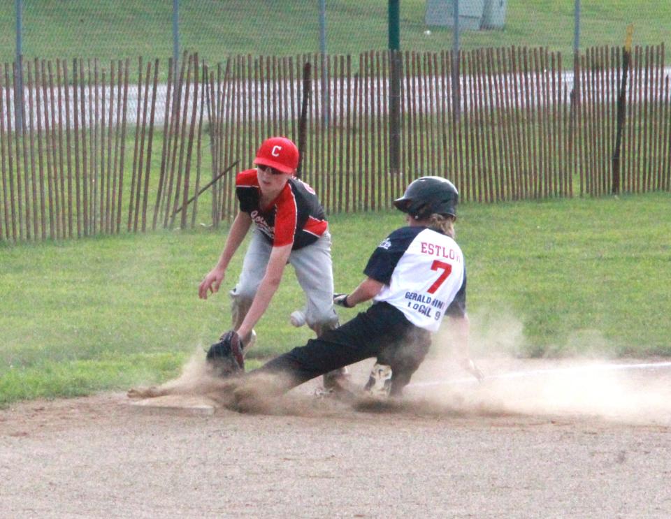 Quincy's Bryson Estlow slides safely into third while Coldwater's Will Knowlon looks to apply the tag on Tuesday