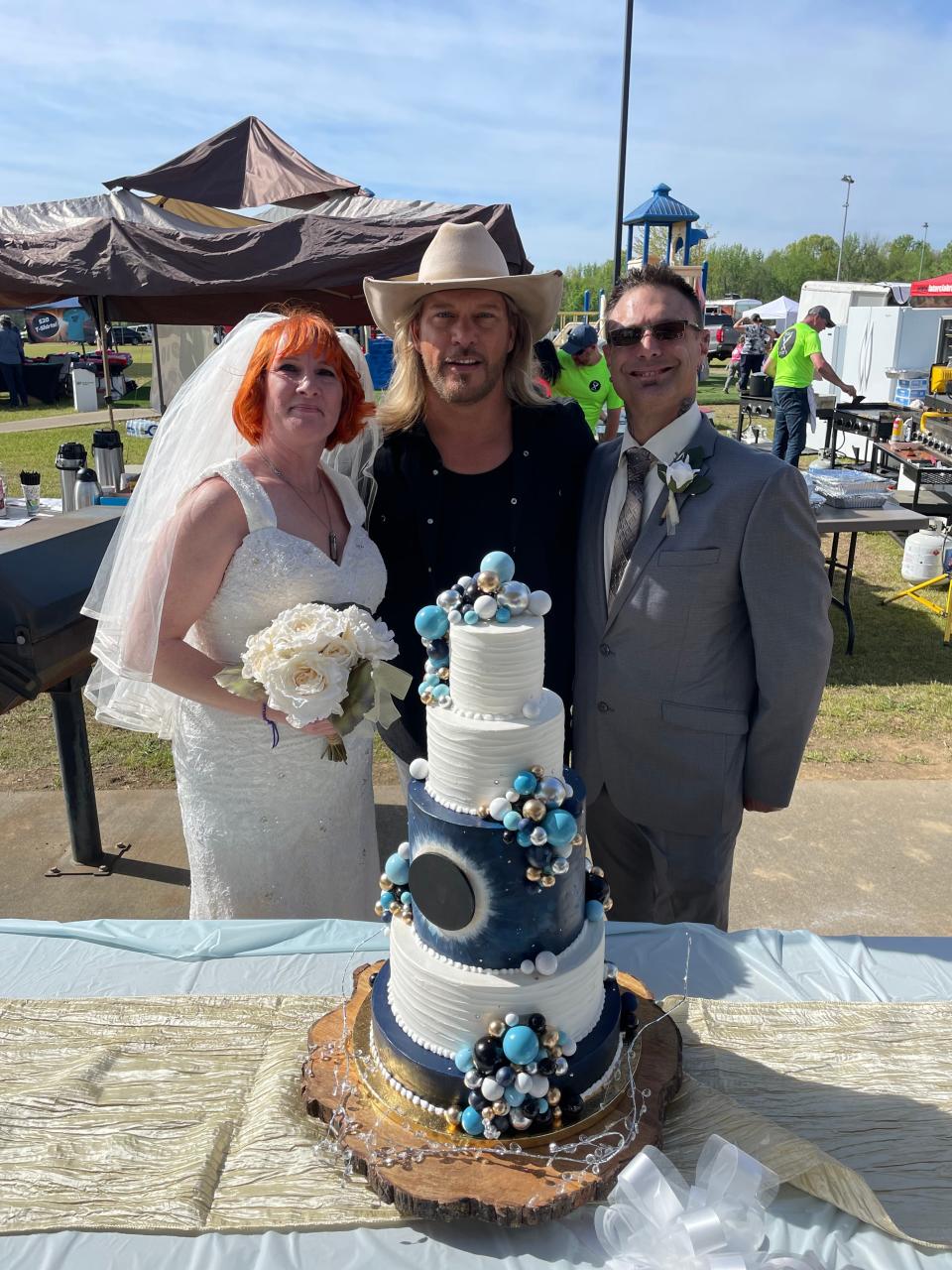 Country singer Craig Wayne Boyd (center) poses with a newlywed couple at Total Eclipse of the Heart in Russellville, Arkansas.