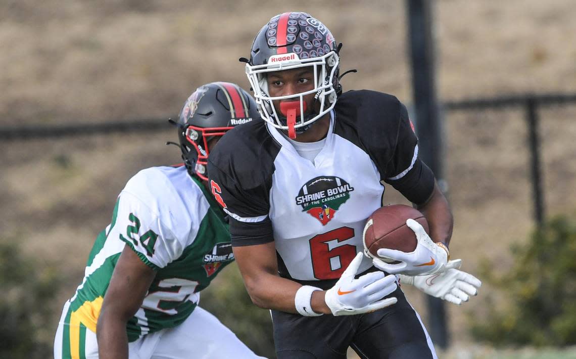 South Carolina receiver Braylon Staley of Strom Thurmond High, Tennessee commit, runs after a catch near North Carolina defensive back Deuce Walker of East Bladen High, committed to Georgia State during the first quarter of the Shrine Bowl of the Carolinas football game at Viking Stadium in Spartanburg, S.C.