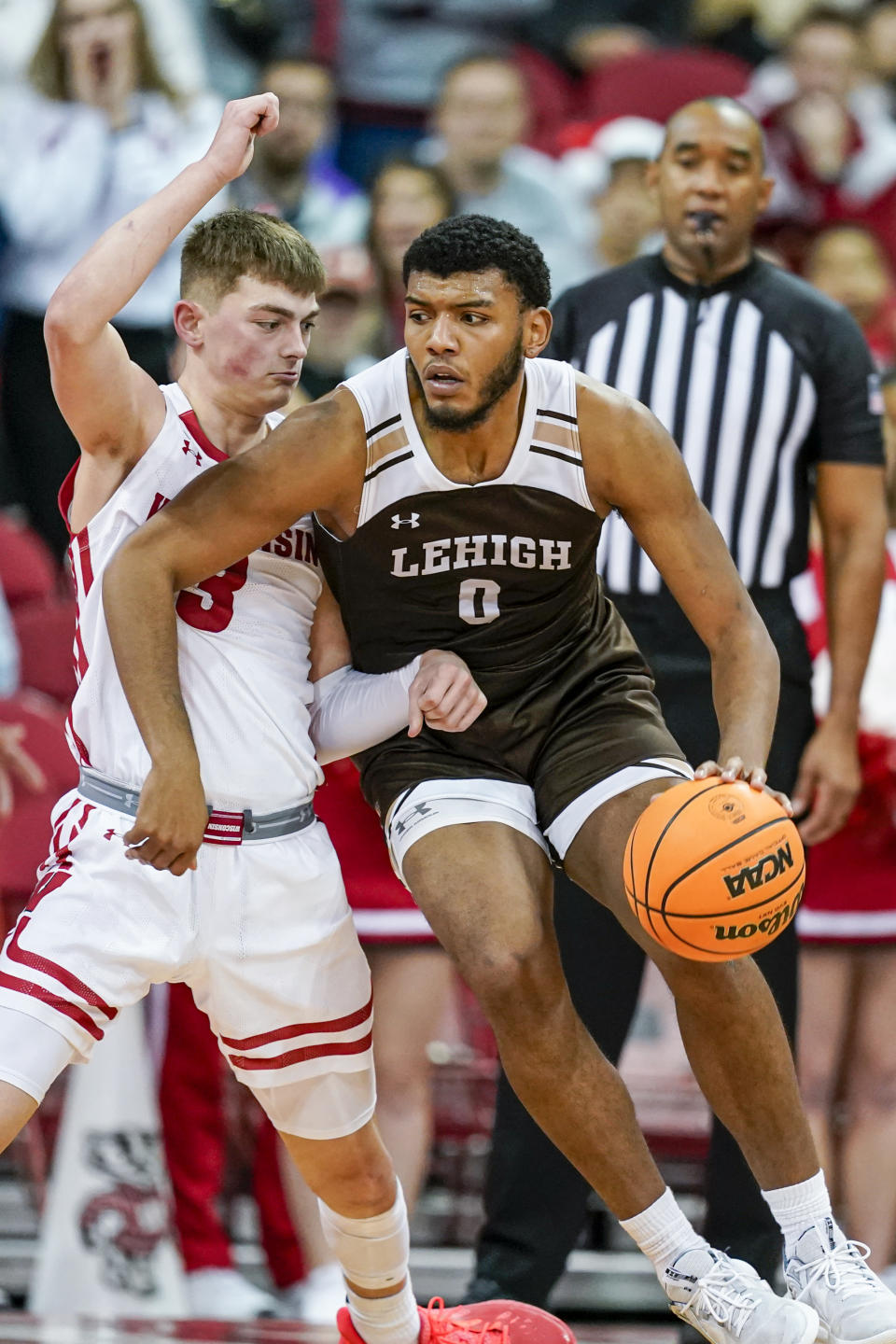 Lehigh's Jakob Alamudun (0) drives against Wisconsin's Connor Essegian (3) during the second half of an NCAA college basketball game Thursday, Dec. 15, 2022, in Madison, Wis. (AP Photo/Andy Manis)