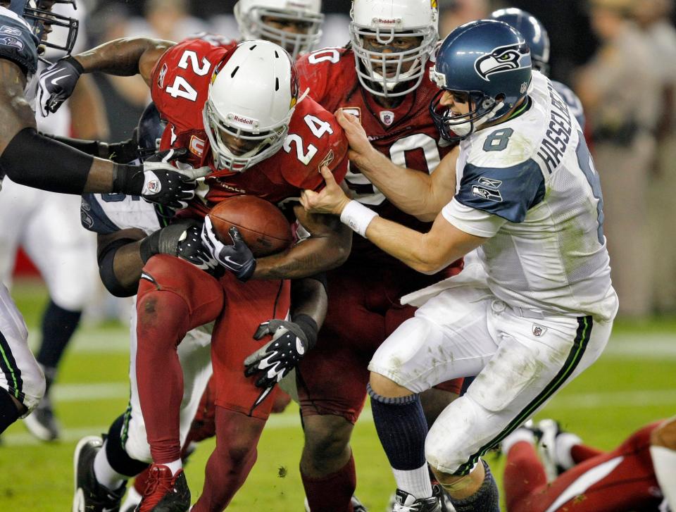 Adrian Wilson (24) is pulled down by Seahawks quarterback Matt Hasselbeck (8) after the Cardinals safety's interception during a game on Nov. 15, 2009.