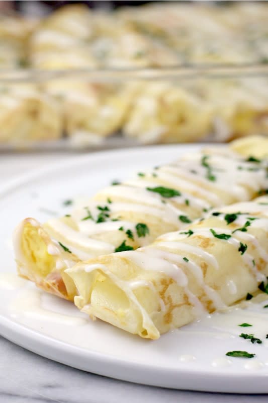 <p>Erica's Recipes</p><p>Tender crepes filled with ham, potato, egg and Gruyère cheese, then topped with a luscious white wine béchamel sauce.</p><p><strong>Get the recipe: <a href="https://ericasrecipes.com/ham-cheese-breakfast-crepes-bechamel/" rel="nofollow noopener" target="_blank" data-ylk="slk:Ham and Cheese Breakfast Crepes with Béchamel;elm:context_link;itc:0;sec:content-canvas" class="link rapid-noclick-resp">Ham and Cheese Breakfast Crepes with Béchamel</a></strong></p>