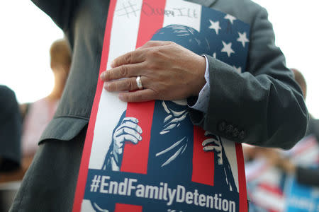 A man attends a protest against conditions in Adelanto Immigration Detention Center, outside ICE headquarters in Los Angeles, California, U.S. July 24, 2018. REUTERS/Lucy Nicholson