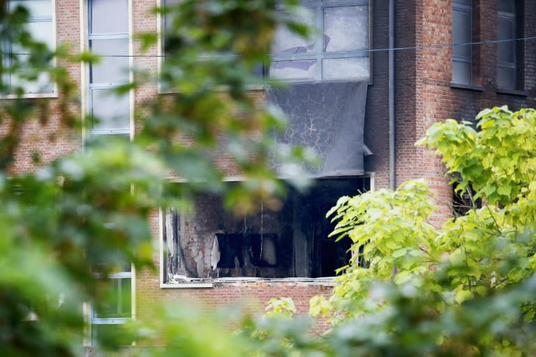 A damaged window at the National Institute for Criminalistics and Criminology (INCC-NICC) in Neder-Over-Heembeek, Belgium pictured on August 29, 2016 after it was hit by an explosion overnight