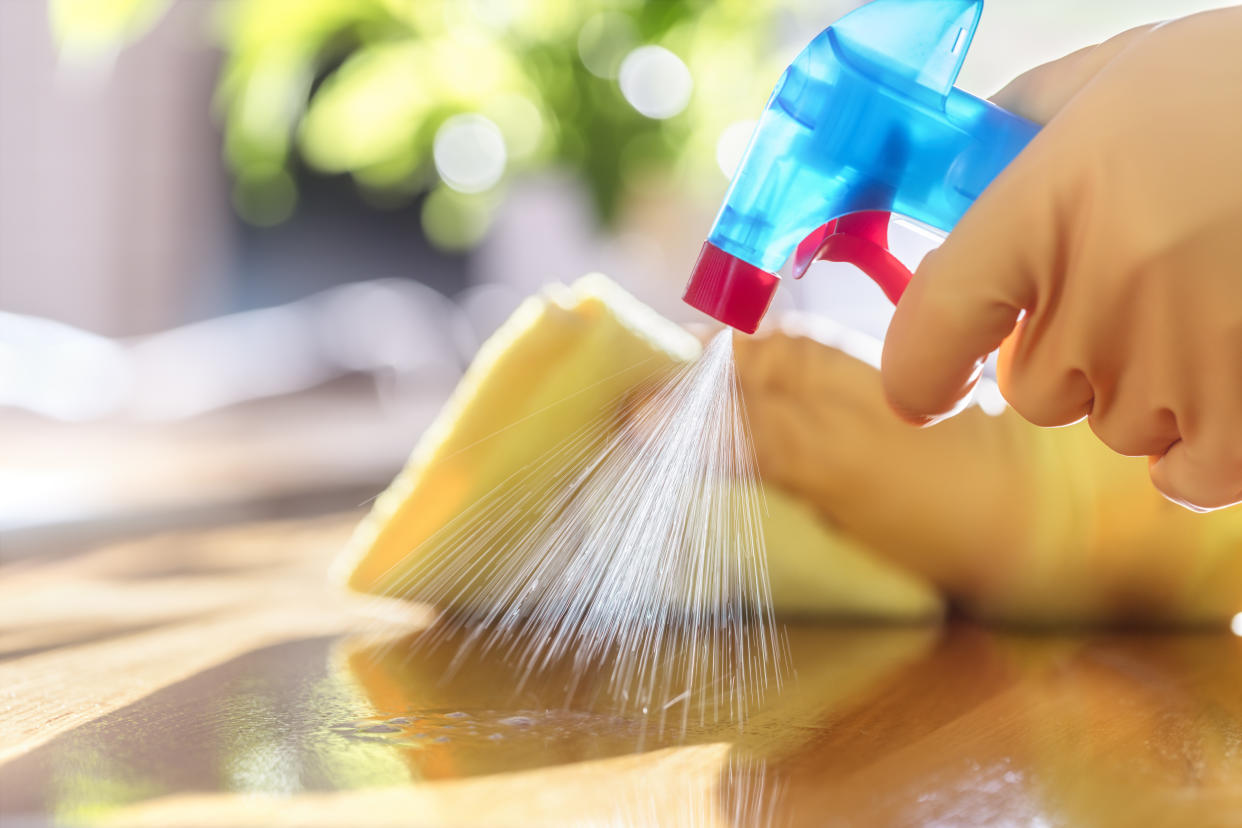 Cleaning with spray detergent, rubber gloves and dish cloth on work surface concept for hygiene