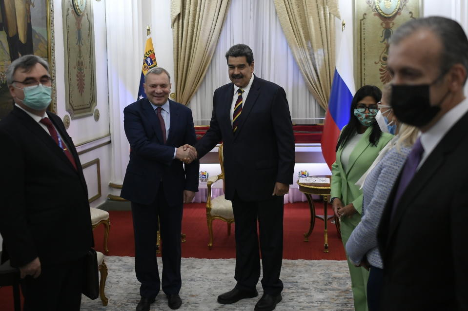 Russia's Deputy Prime Minister Yuri Borisov, left, and Venezuela's President Nicolas Maduro, shake hands during a media presentation at the Presidential Palace in Caracas, Venezuela, Wednesday, Feb. 16, 2022. Venezuelan and Russian officials met for high-level discussions in the South American country Wednesday, a day after diplomats from the U.S. and several other nations gathered to discuss steps toward a negotiated solution to the country’s protracted crisis. (AP Photo/Matias Delacroix)