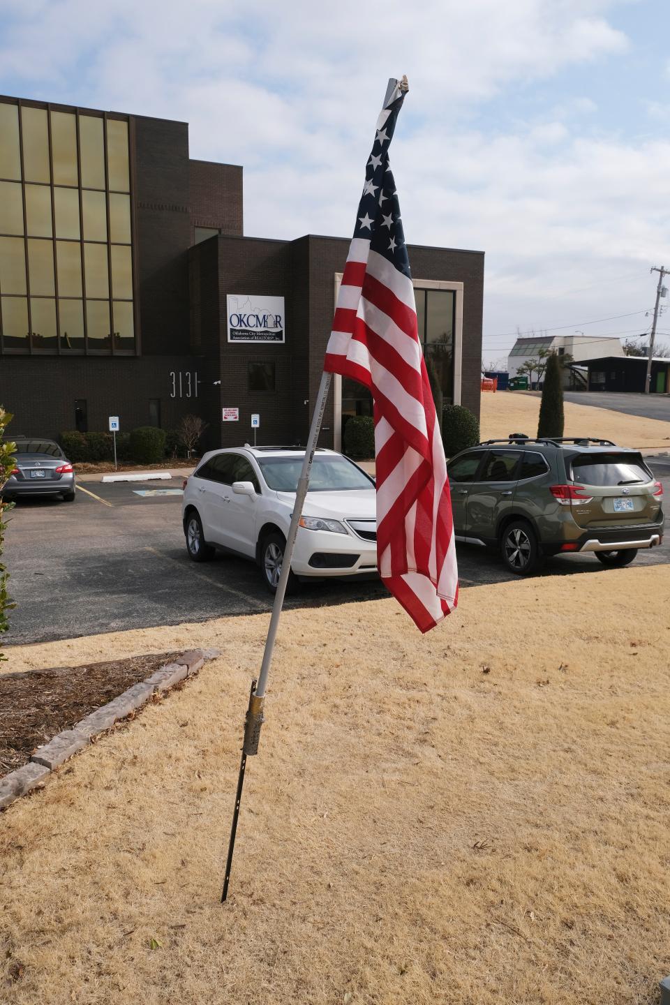 An American flag flies on a makeshift pole outside the Oklahoma City Metro Association of Realtors, 3131 Northwest Expressway. The flag went up Thursday morning after an explosion of outrage on Facebook in response to the removal of a flag court that displayed the U.S. flag and others.